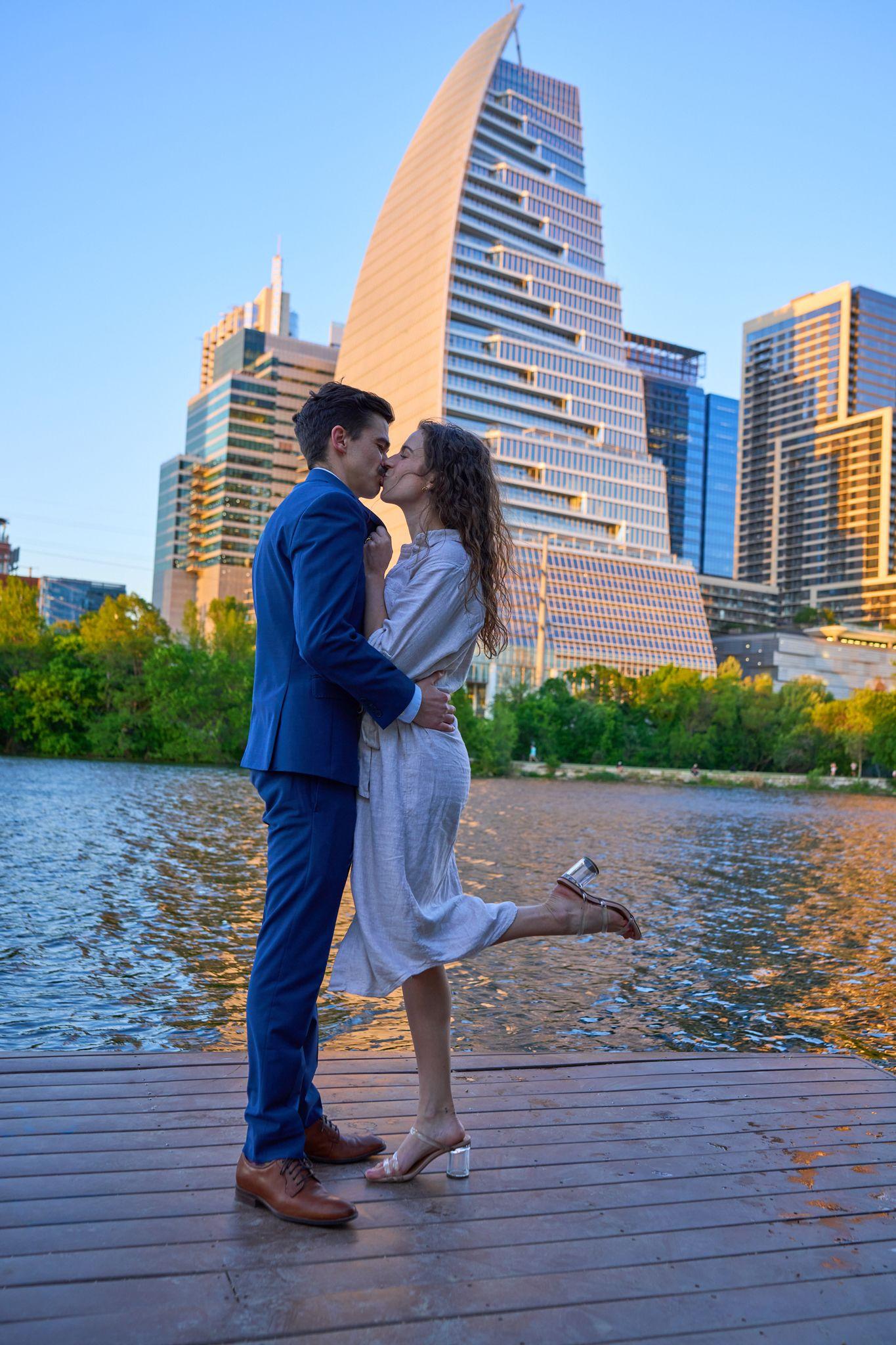 Couple embracing on the boardwalk at Lady Bird Lake, the downtown Austin skyline rising — Butler Metro Park photography, Austin A couple embracing on the boardwalk at Lady Bird Lake, the downtown Austin skyline rising behind them.