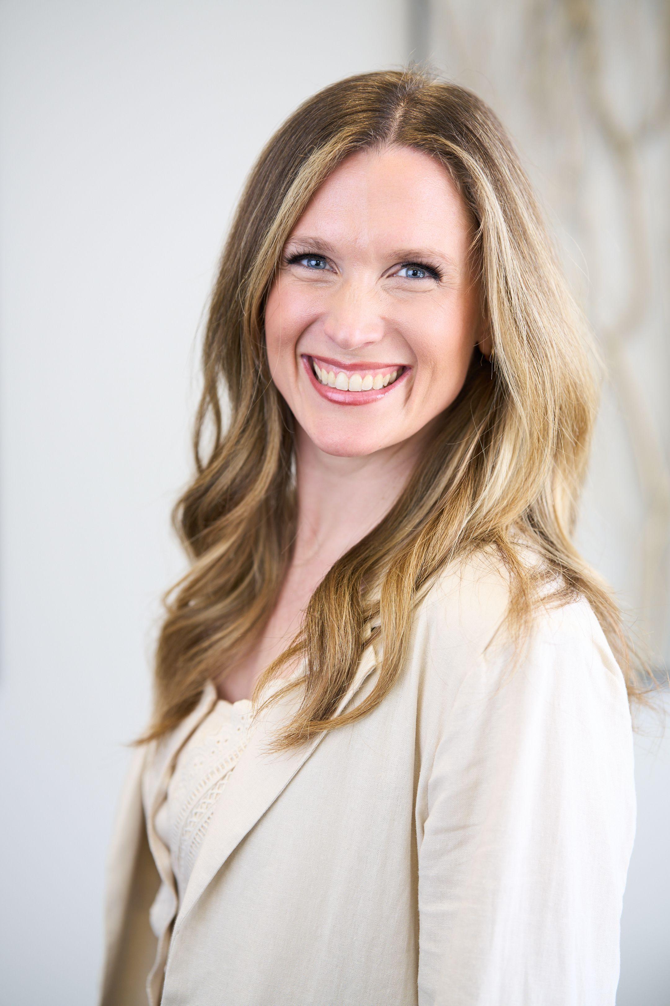 Woman with long blonde hair in a cream top smiling against a soft background — Headshot photography, Austin A woman with long blonde hair in a cream top smiling against a soft background.