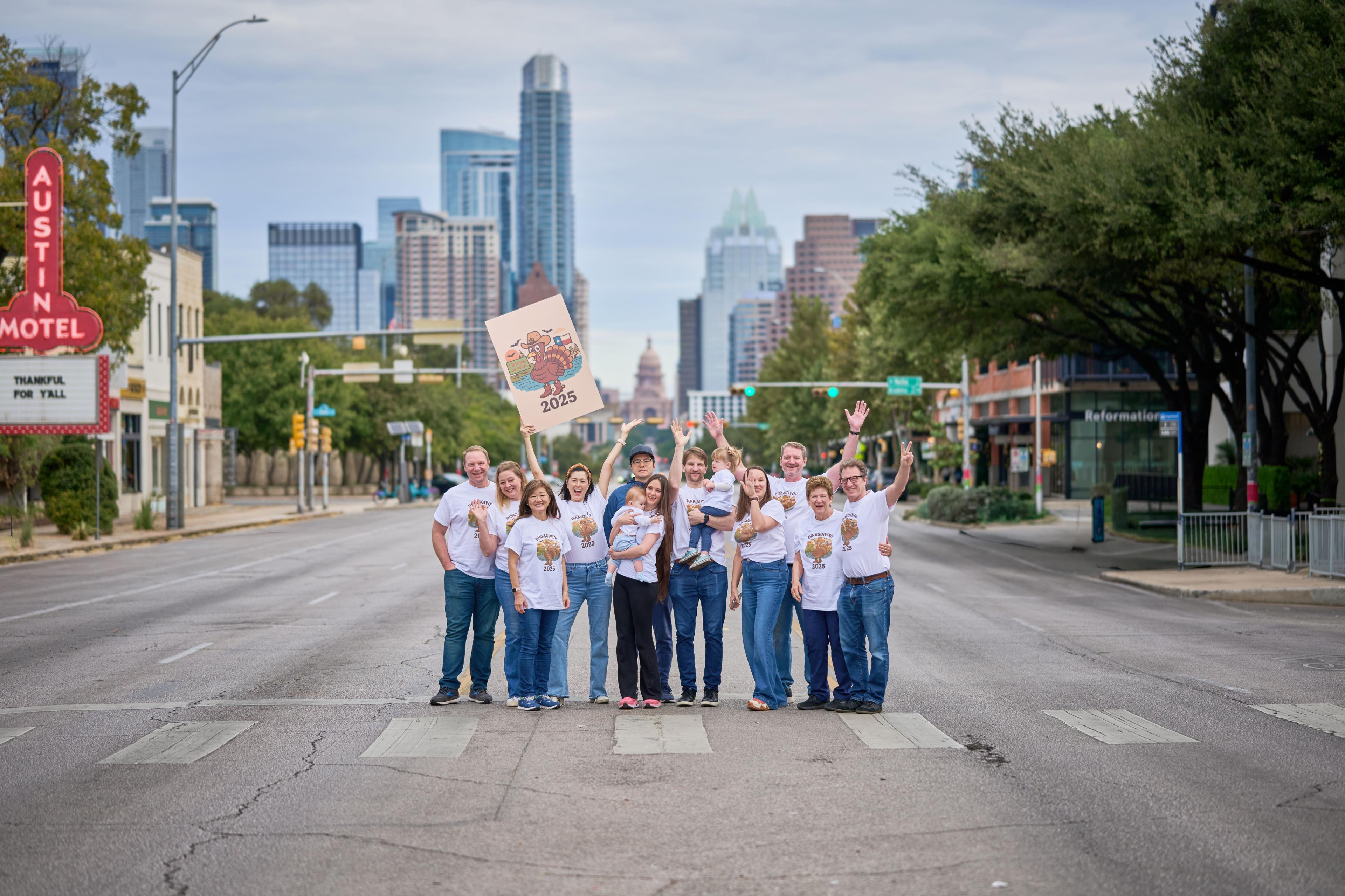 Large extended family in matching shirts standing on Congress Avenue — Family Portraits photography, Austin Family Portraits