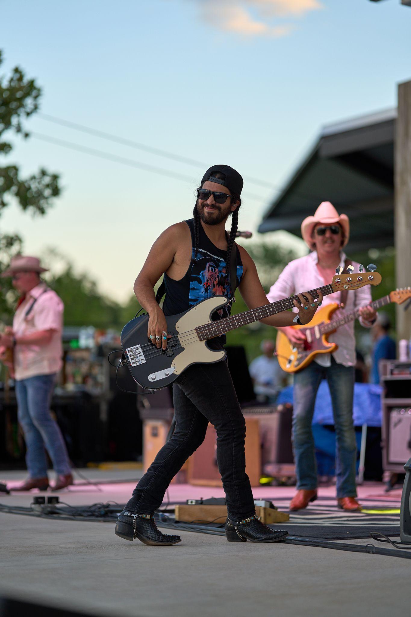 Bassist and guitarist performing on an outdoor festival stage — Festival photography, Austin A bassist and guitarist performing on an outdoor festival stage.