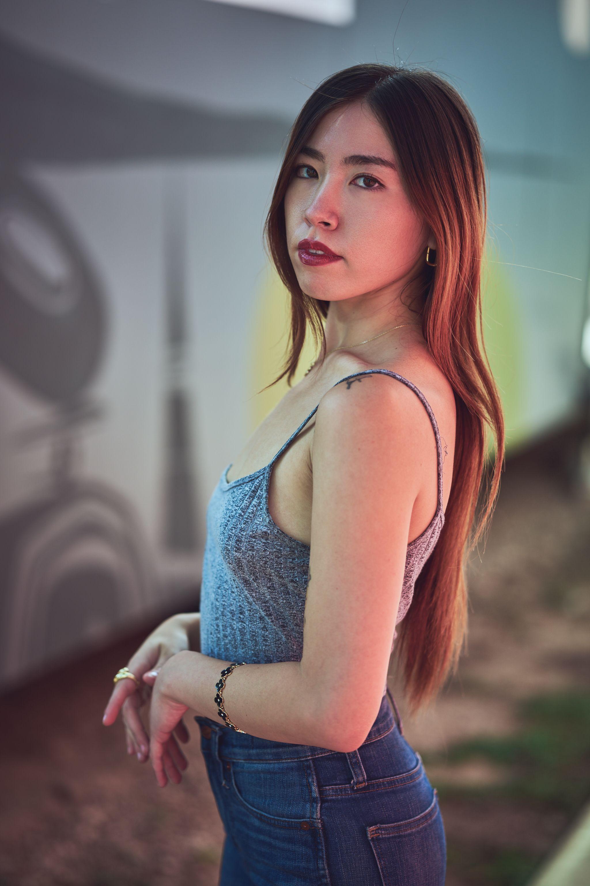 Model in a gray knit cami standing against a painted mural in cool blue light — Fashion & editorial photography, Austin A model in a gray knit cami standing against a painted mural in cool blue light.