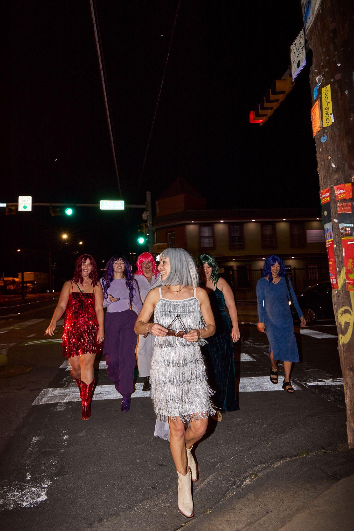 Group in party dresses crossing a downtown street at night — Downtown Austin photography, Austin A group in party dresses crossing a downtown street at night.