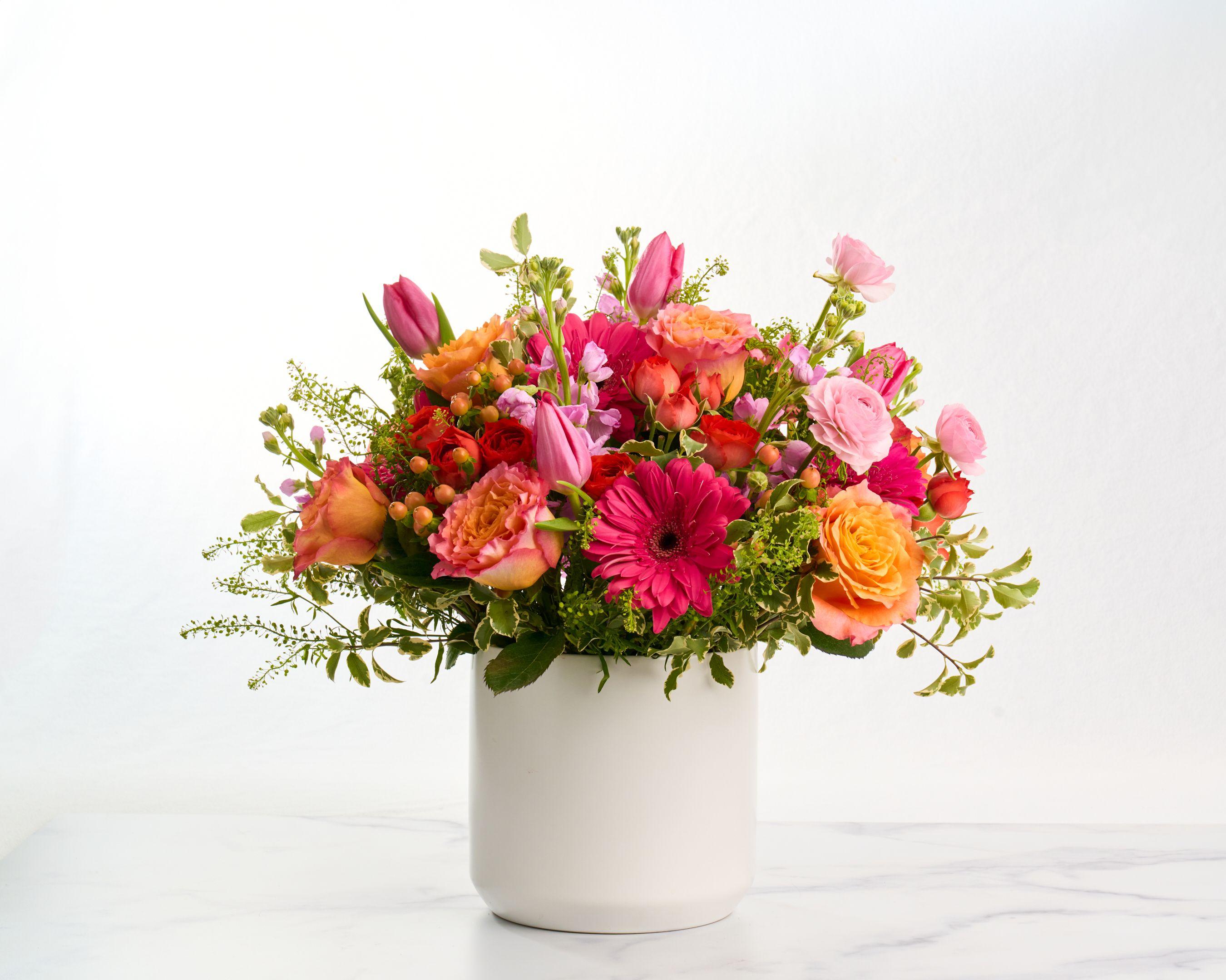 Pink and orange floral arrangement with gerberas and roses in a white ceramic pot — E-commerce & apparel photography, Austin Pink and orange floral arrangement with gerberas and roses in a white ceramic pot