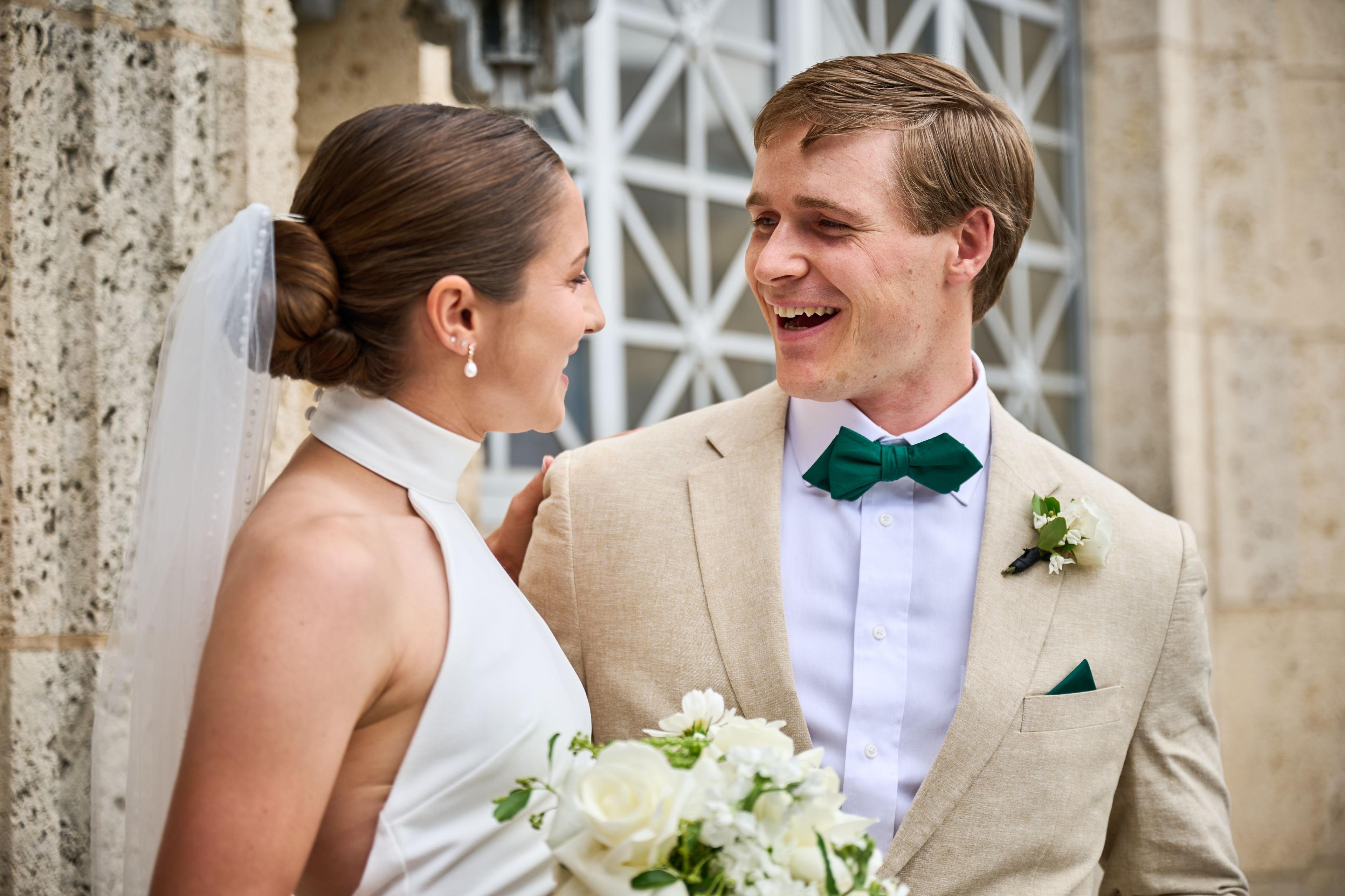 Bride and groom laughing together, her hand on his lapel, bouquet held below — Elopements photography, Austin A bride and groom laughing together, her hand on his lapel, bouquet held below.