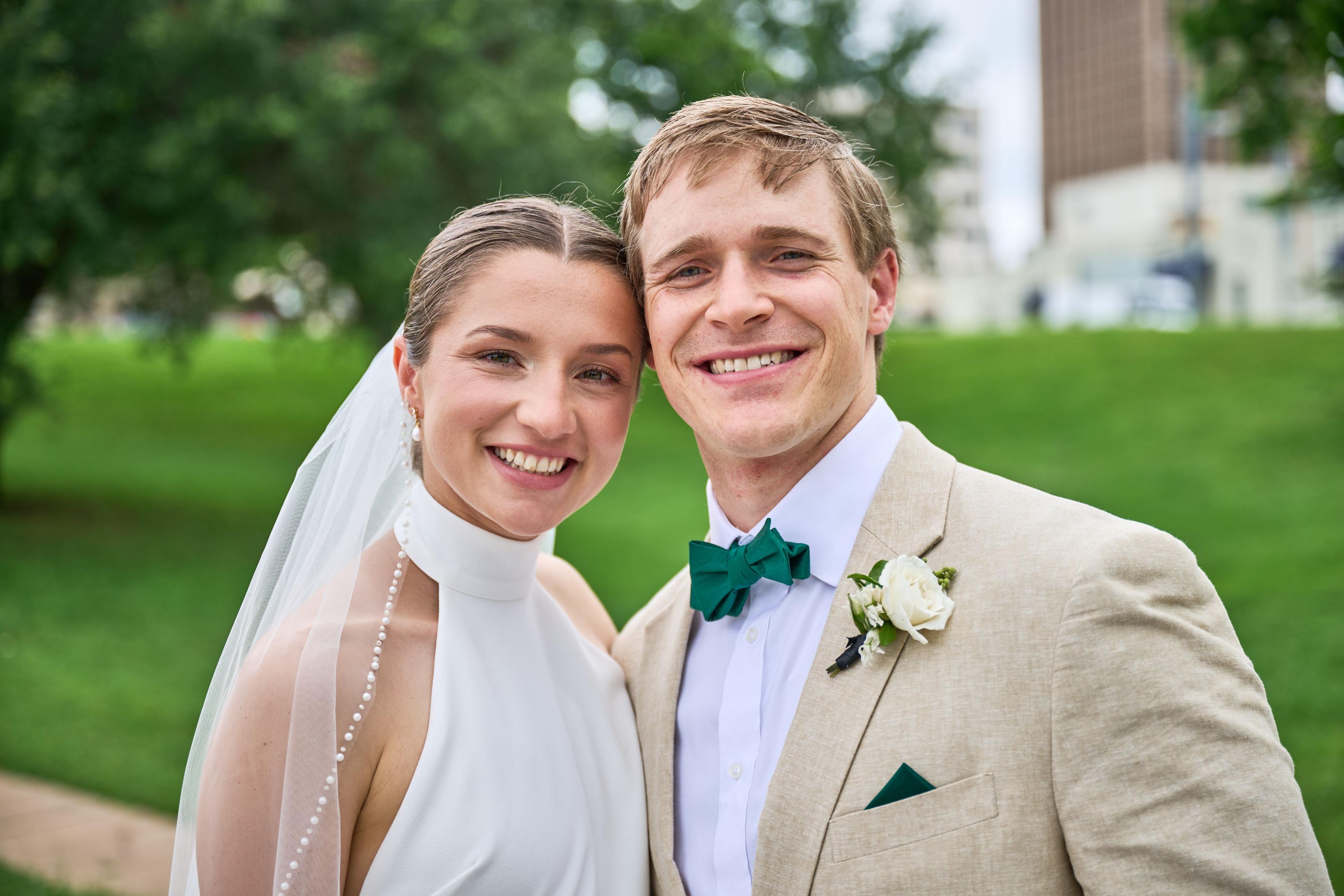 Close portrait of a bride and groom smiling together on a green lawn — Weddings photography, Austin A close portrait of a bride and groom smiling together on a green lawn.