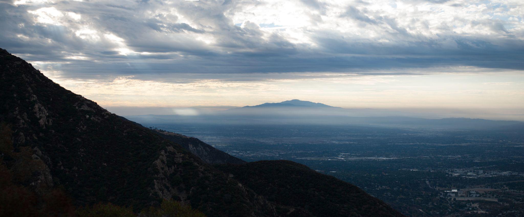 Mountain ridge rising above a valley of low cloud at dawn — Adventure & outdoor photography, Austin A mountain ridge rising above a valley of low cloud at dawn.