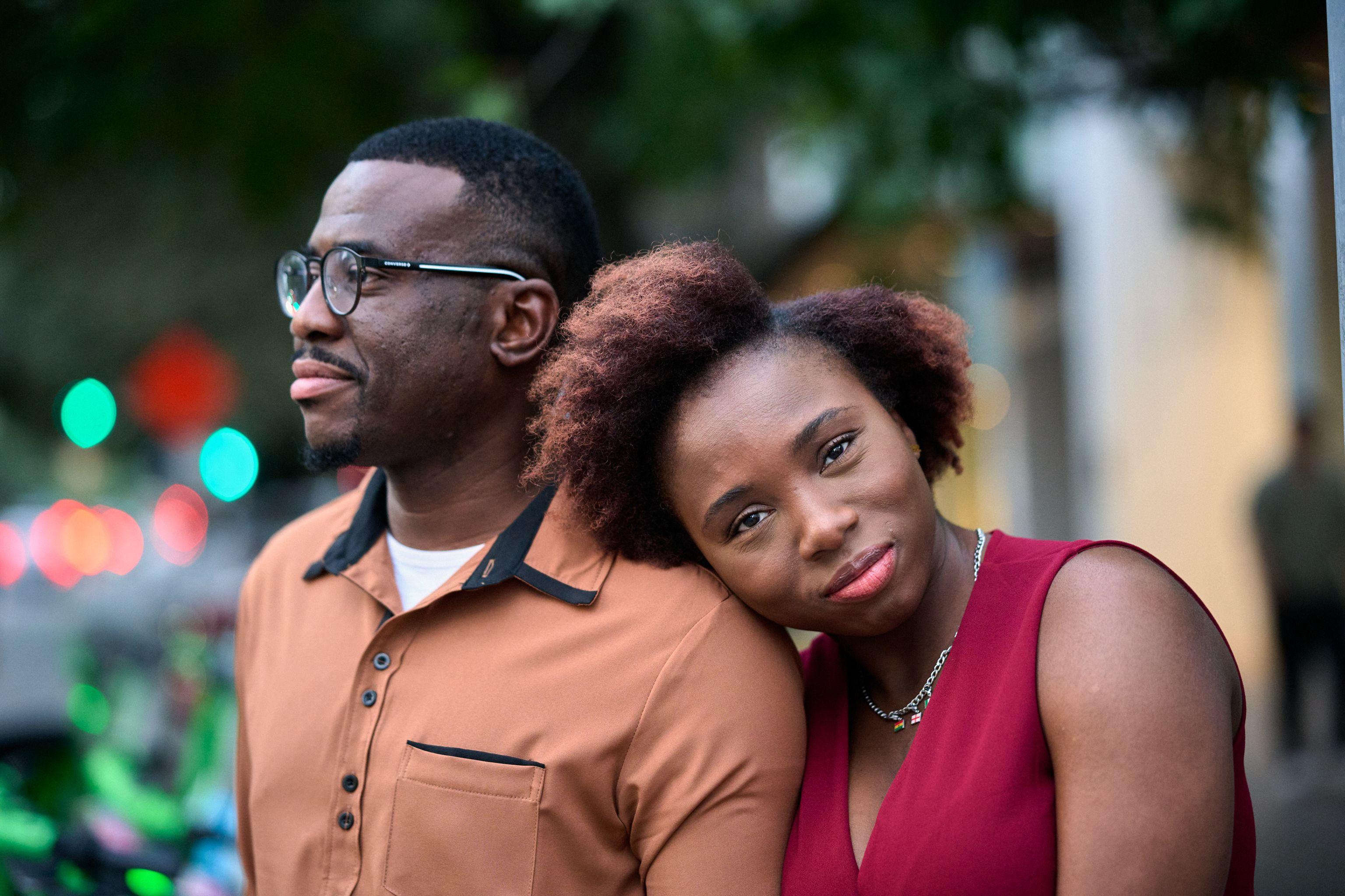 Couple standing cheek to cheek in warm evening light on the avenue — Congress Avenue photography, Austin A couple standing cheek to cheek in warm evening light on the avenue.
