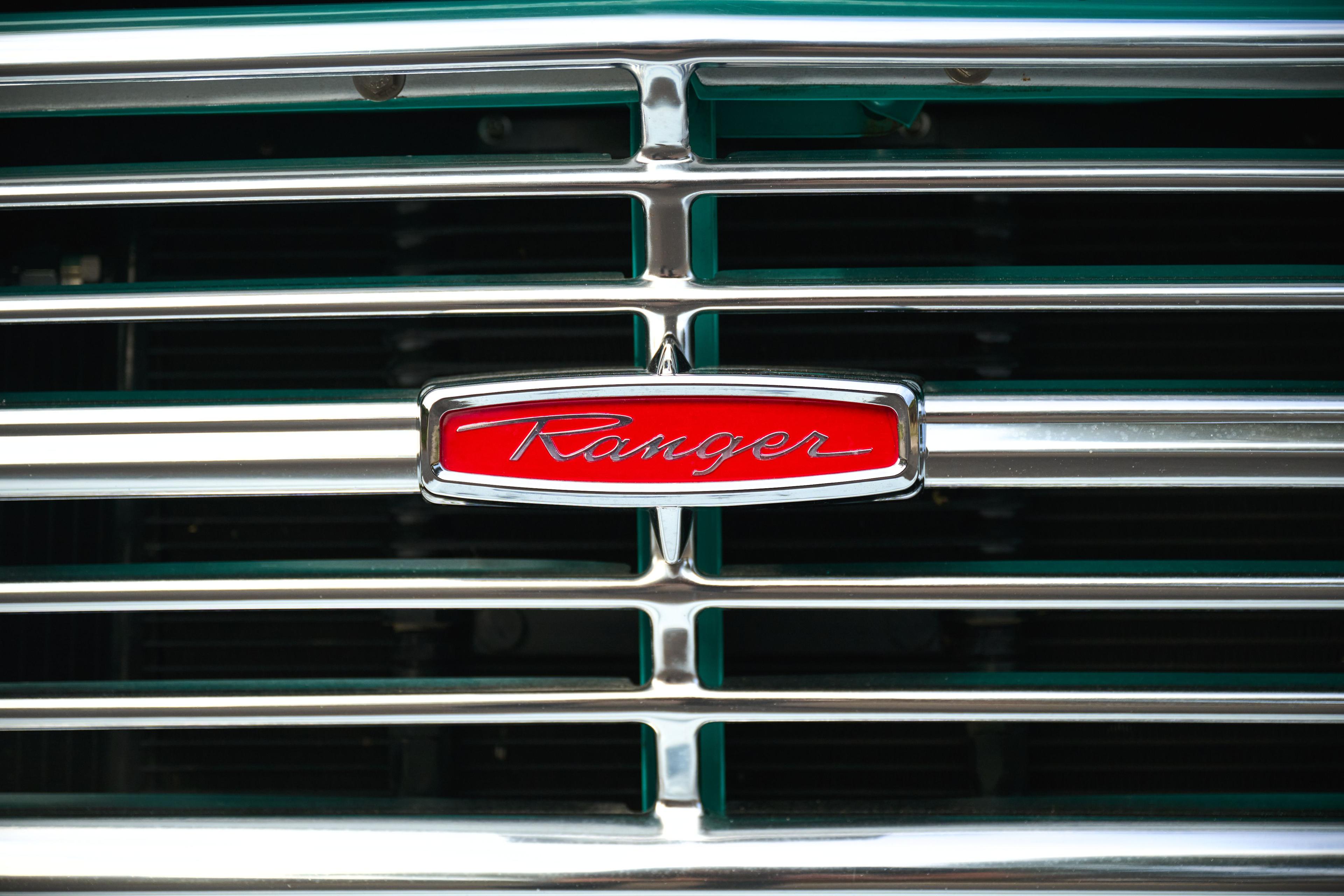 Close detail of the chrome grille and red Ranger badge on a classic Ford truck — Automotive photography, Austin A close detail of the chrome grille and red Ranger badge on a classic Ford truck.