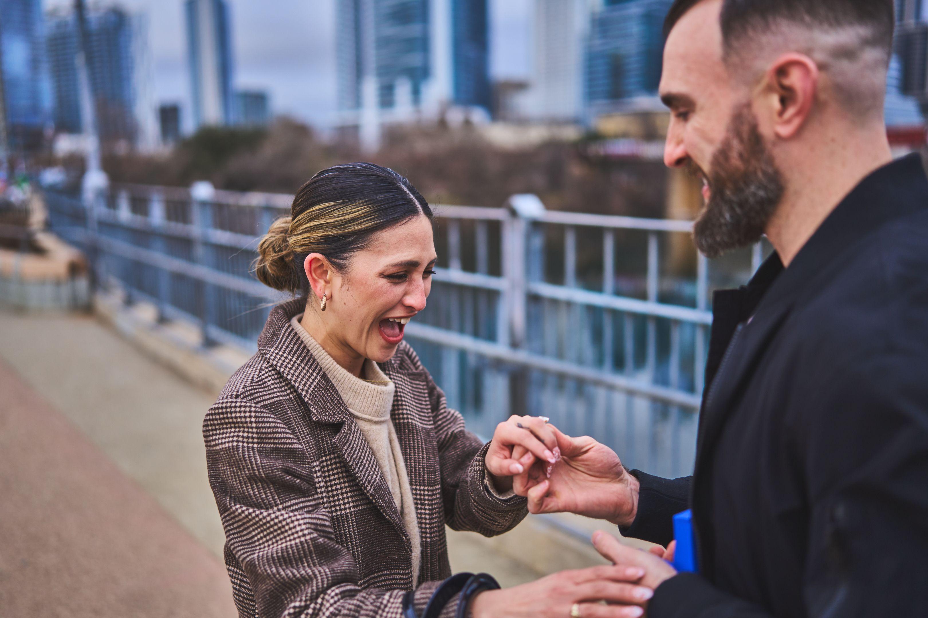 Newly engaged woman laughing through tears as the ring is slipped onto her finger — Engagement & Proposals photography, Austin A newly engaged woman laughing through tears as the ring is slipped onto her finger.