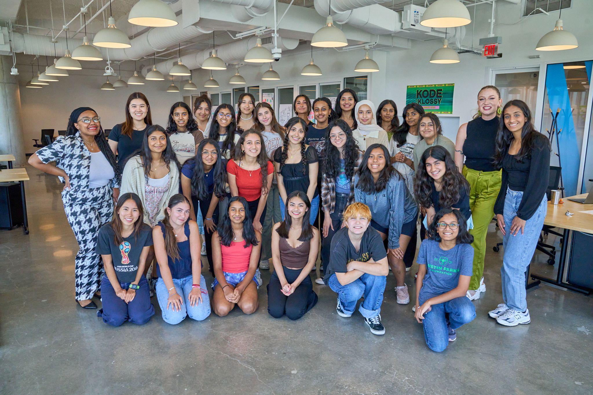 Large group of students posed together in a school hall, some kneeling at the front — School event photography, Austin Large group of students posed together in a school hall, some kneeling at the front