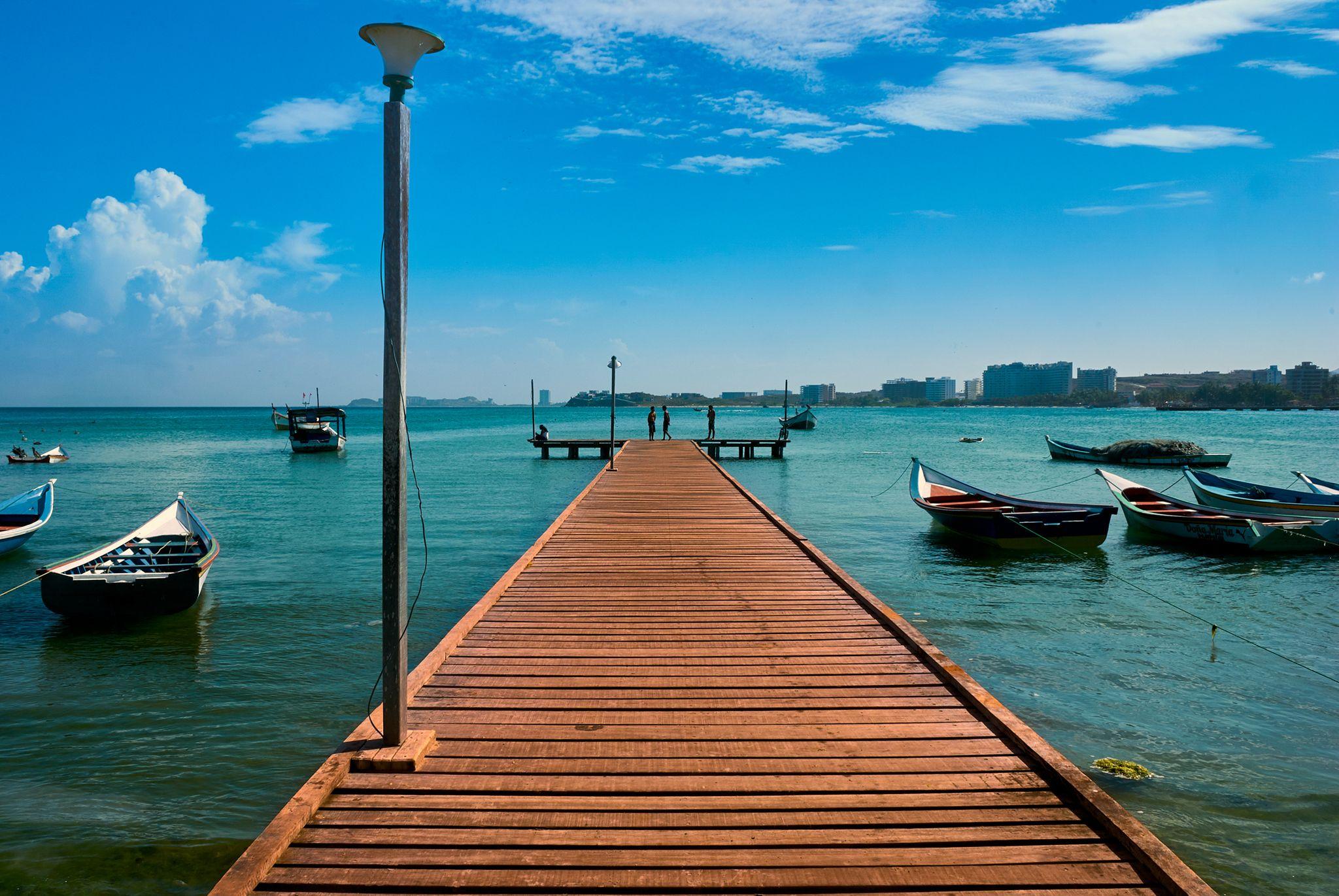 Long wooden dock reaching out over turquoise water — Adventure & outdoor photography, Austin A long wooden dock reaching out over turquoise water.