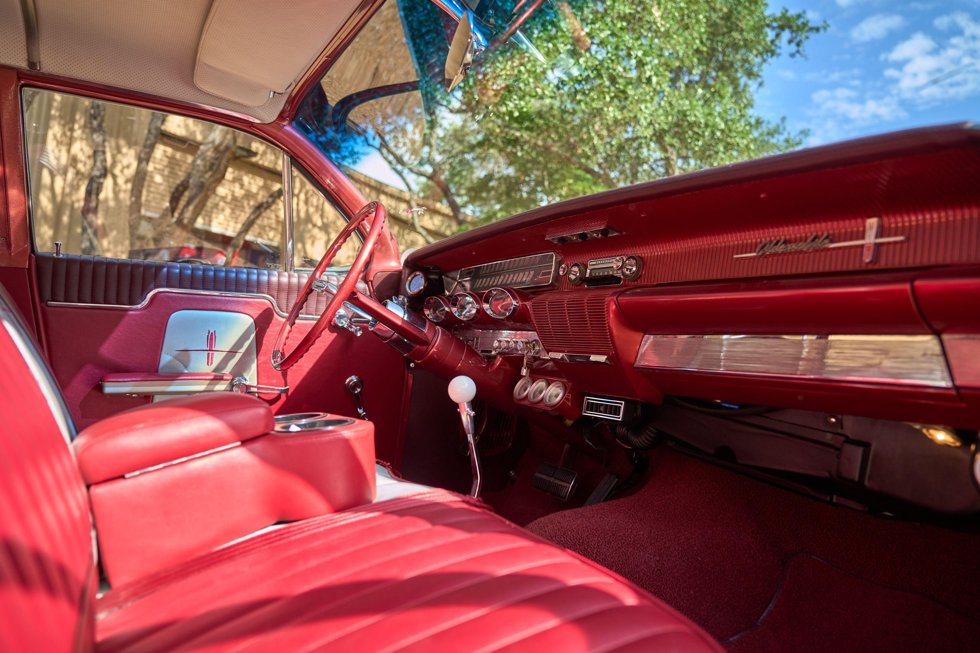 Red upholstered interior and dashboard of a classic convertible — Automotive photography, Austin The red upholstered interior and dashboard of a classic convertible.