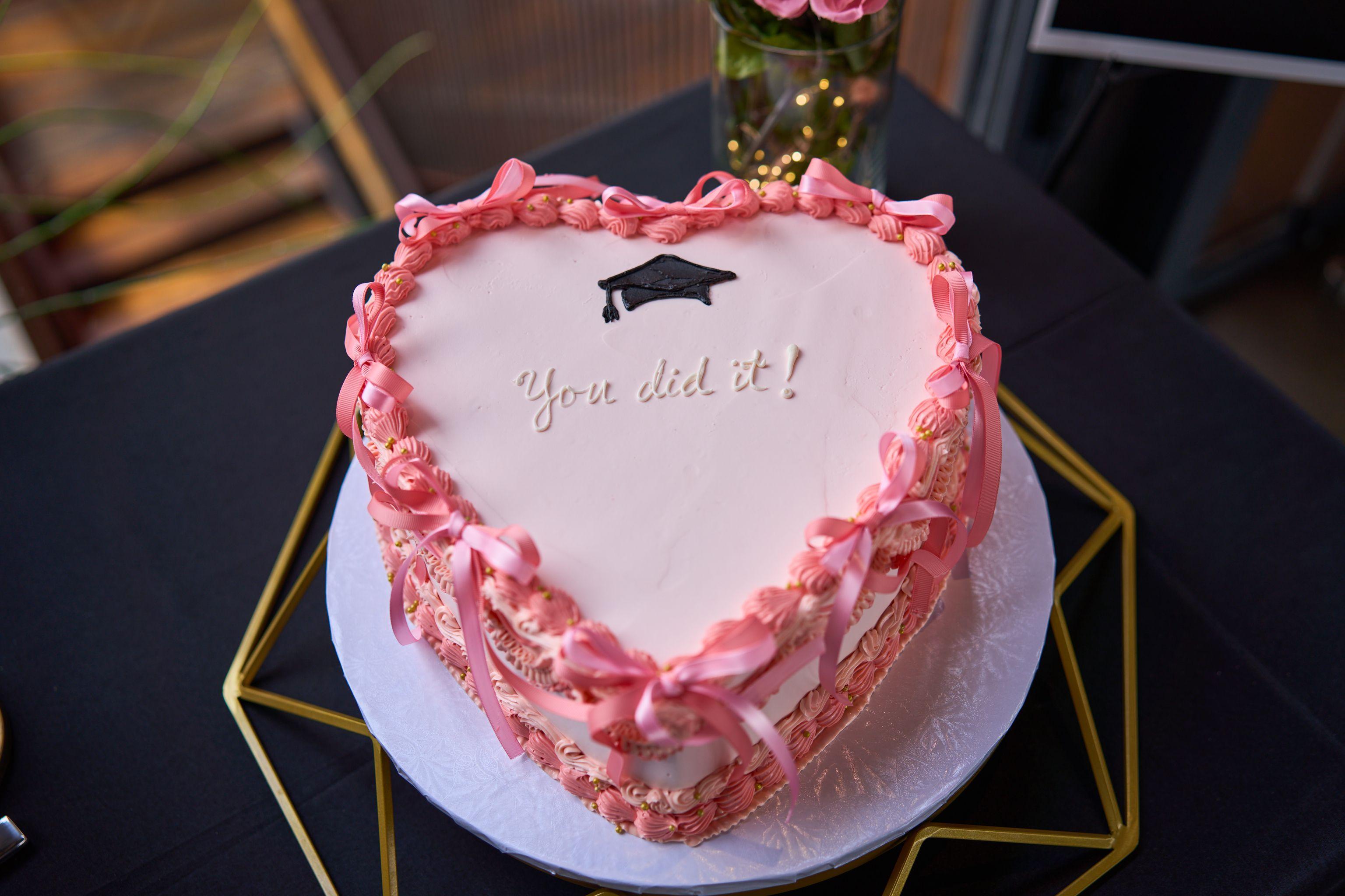 Pink heart-shaped graduation cake reading 'You did it!' with a sugar mortarboard — Graduation & Prom photography, Austin A pink heart-shaped graduation cake reading 'You did it!' with a sugar mortarboard.