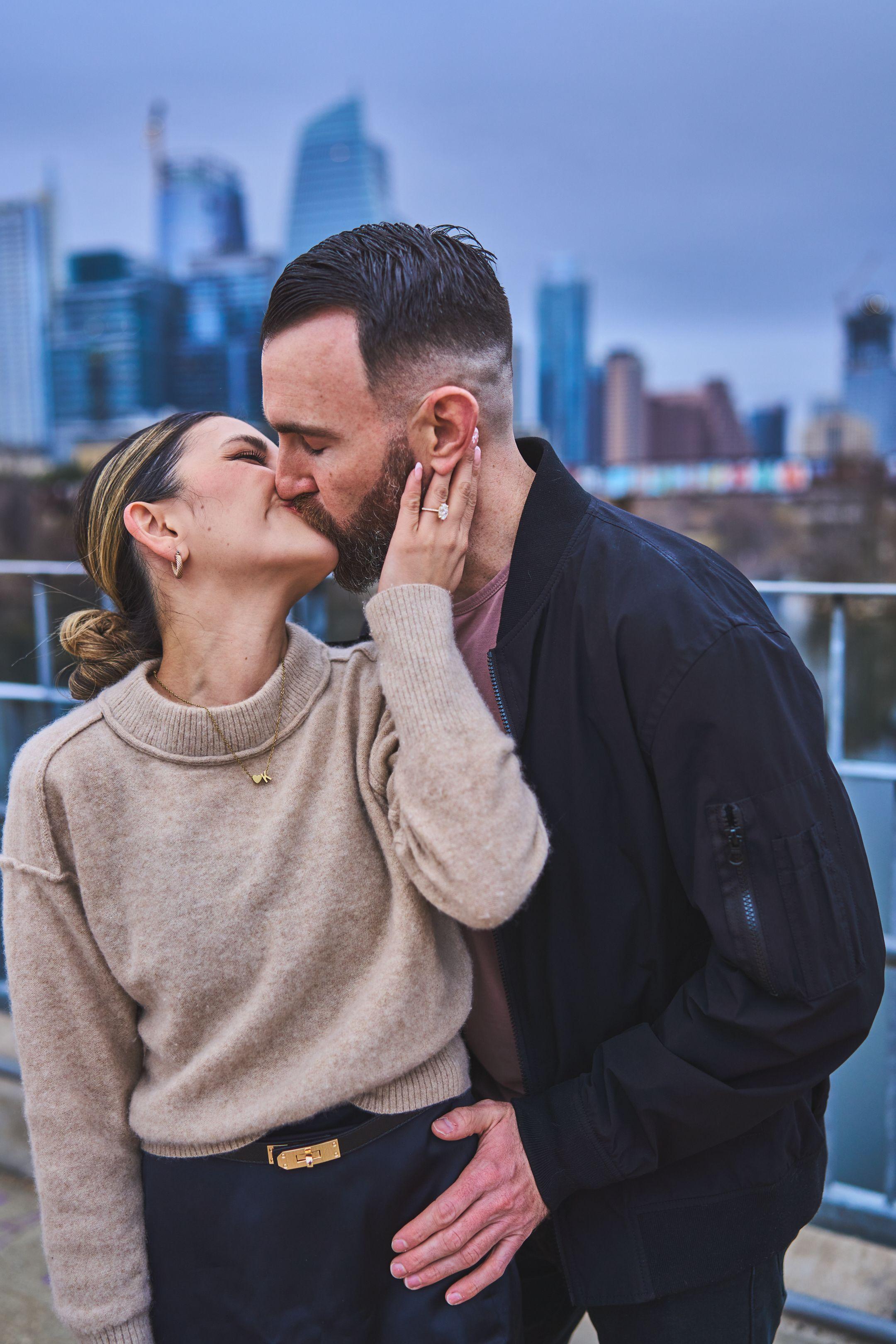 Couple kissing on the pedestrian bridge moments after the proposal — Engagement & Proposals photography, Austin A couple kissing on the pedestrian bridge moments after the proposal.