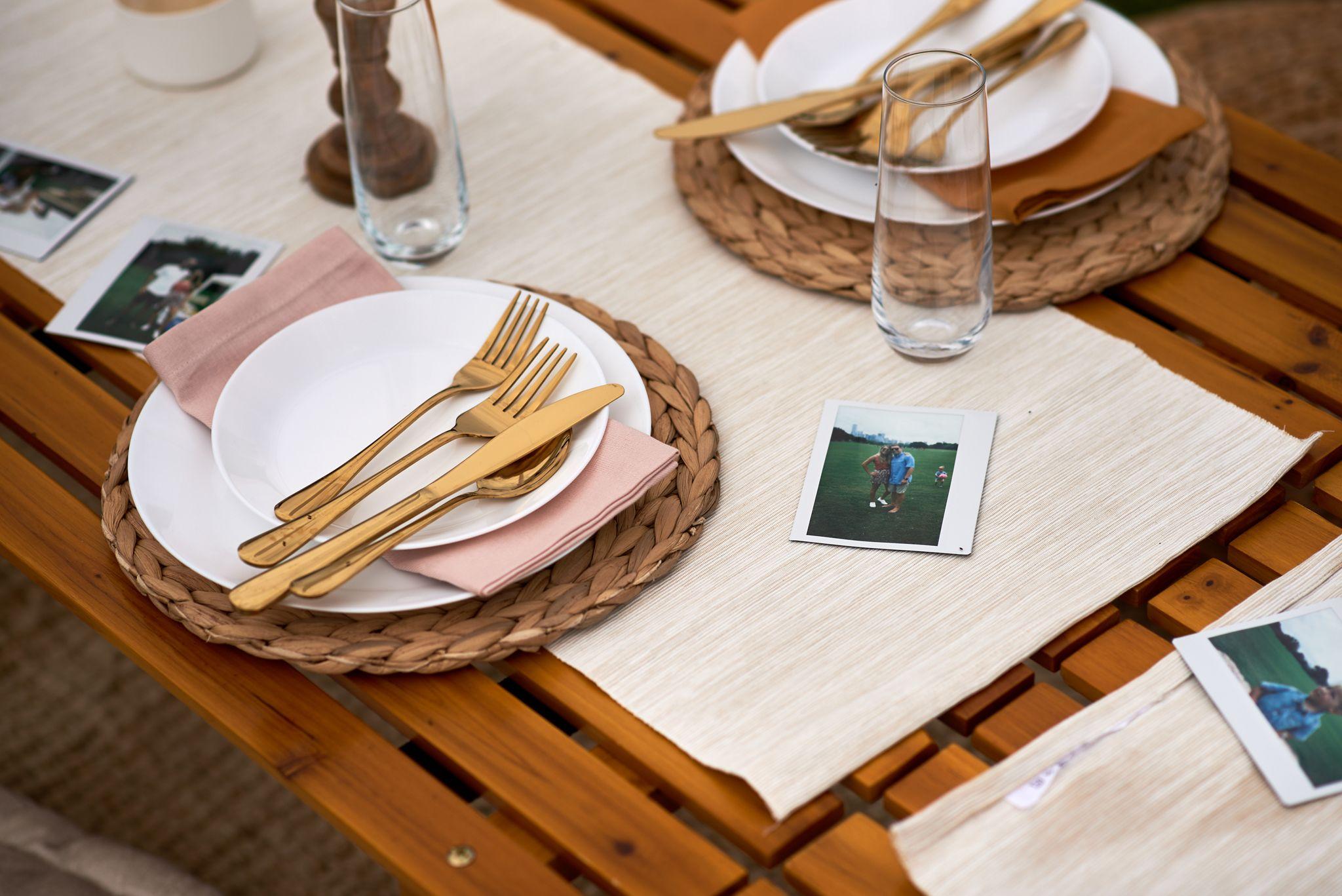 Table setting with gold cutlery and woven placemats — Hospitality & leisure photography, Austin A table setting with gold cutlery and woven placemats.