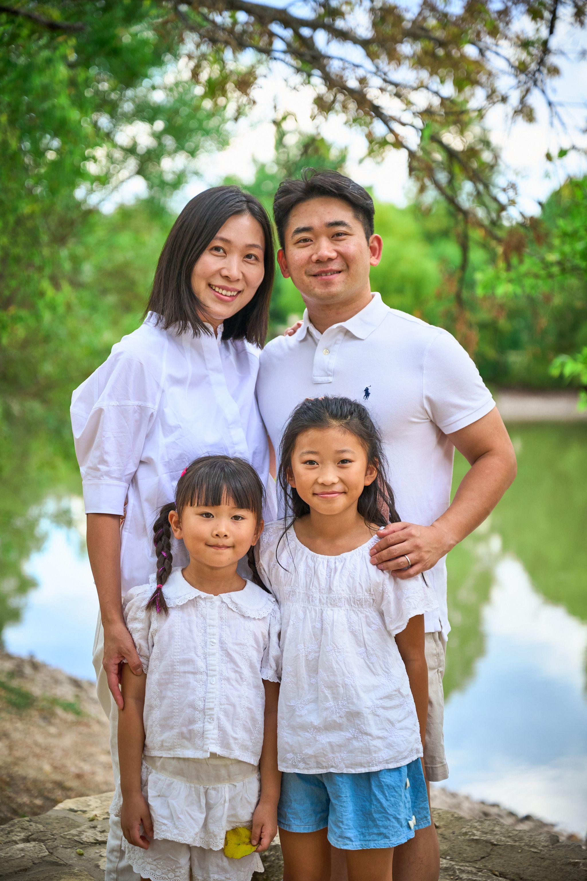 Family of four in white standing at the water's edge at Mills Pond — Mills Pond photography, Austin A family of four in white standing at the water's edge at Mills Pond
