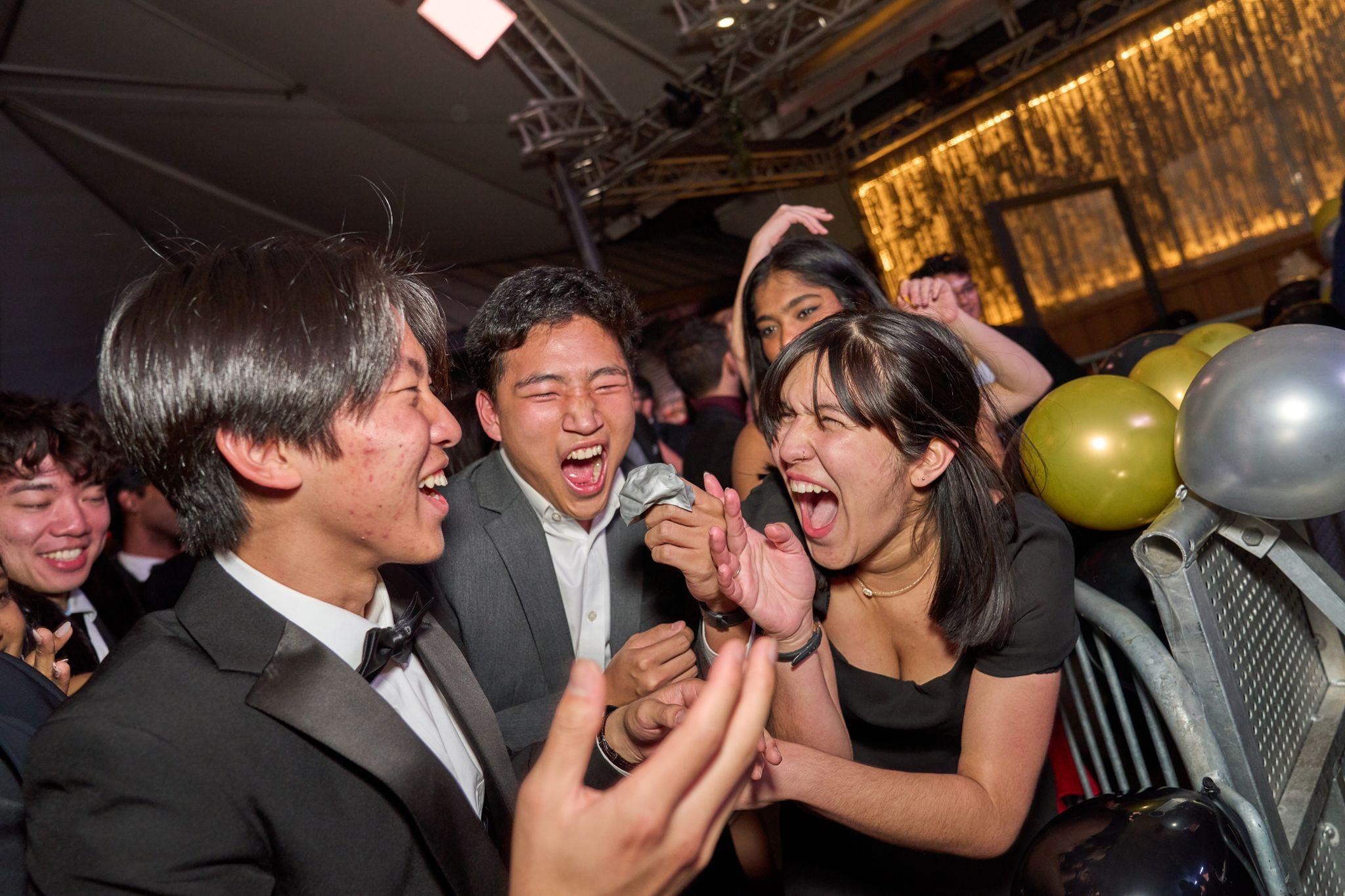 Guests in black tie laughing and dancing together on a crowded floor — Party & nightlife photography, Austin Guests in black tie laughing and dancing together on a crowded floor.