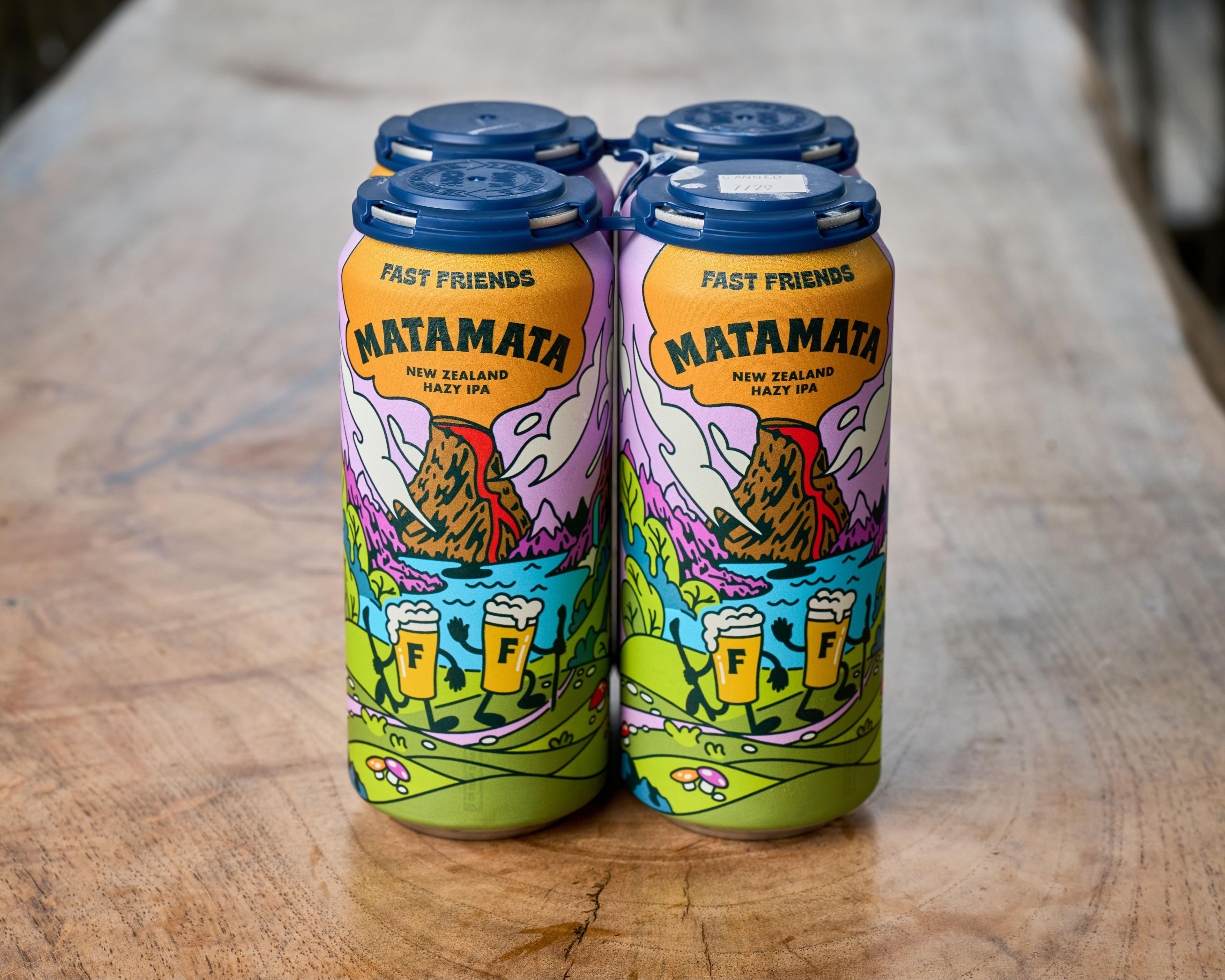 Two four-packs of Matamata hazy IPA cans on a wooden surface — Product photography, Austin Two four-packs of Matamata hazy IPA cans on a wooden surface.