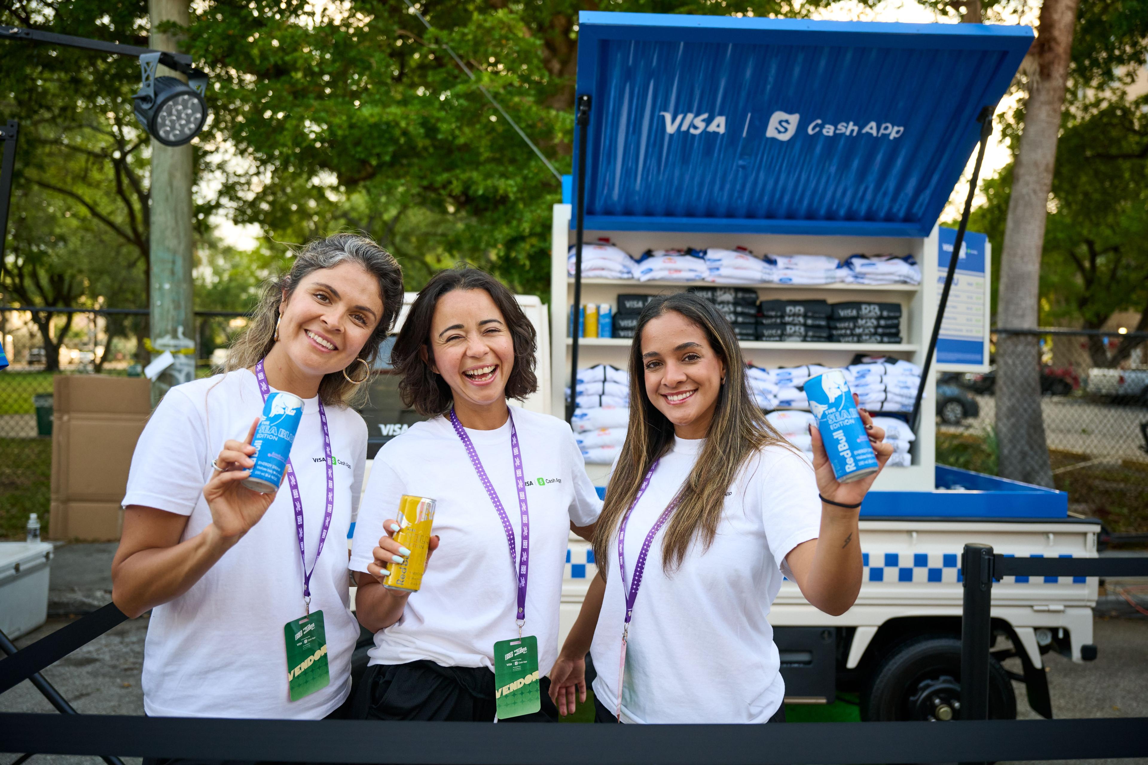 Three brand staffers in white shirts holding drinks in front of a Visa — Brand Collaborations photography, Austin Three brand staffers in white shirts holding drinks in front of a Visa and Cash App branded truck.