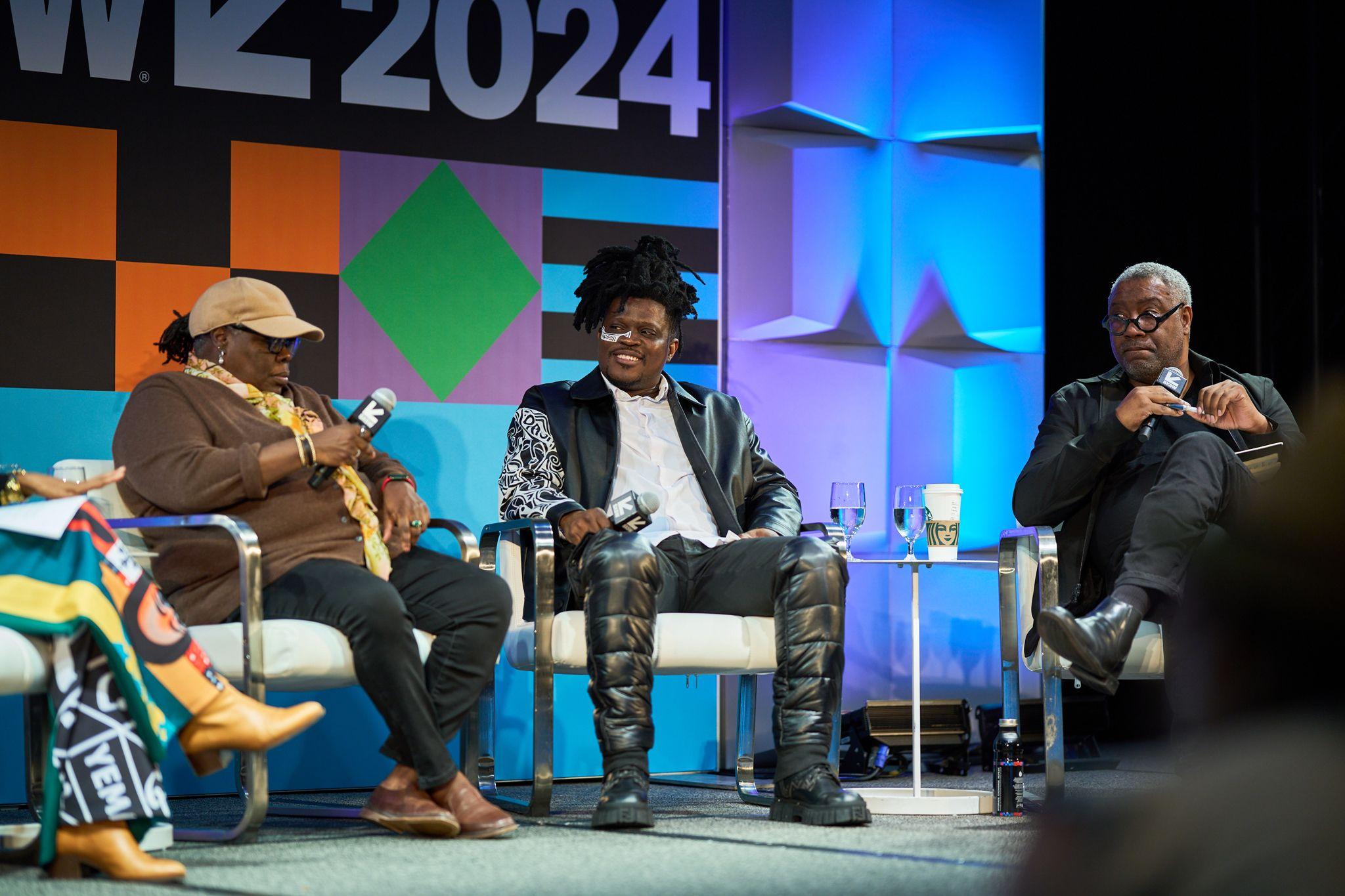 Panelist speaking into a handheld microphone on a blue and green lit SXSW 2024 stage — Conventions & Tradeshows photography, Austin A panelist speaking into a handheld microphone on a blue and green lit SXSW 2024 stage.